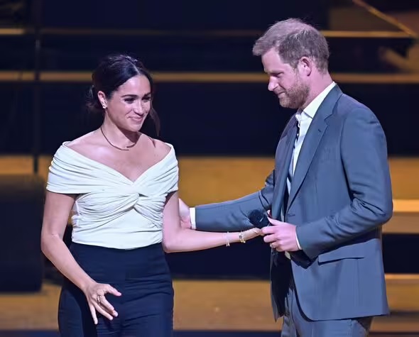 Meghan Markle's silent 'cry for help' while Prince Harry was away spotted by onlookers